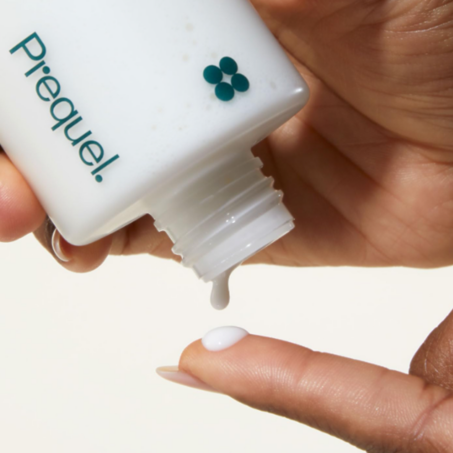 Prequel half & half lightweight moisturiser being poured onto a fingertip
